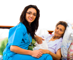 nurse taking care of an elderly woman in bed